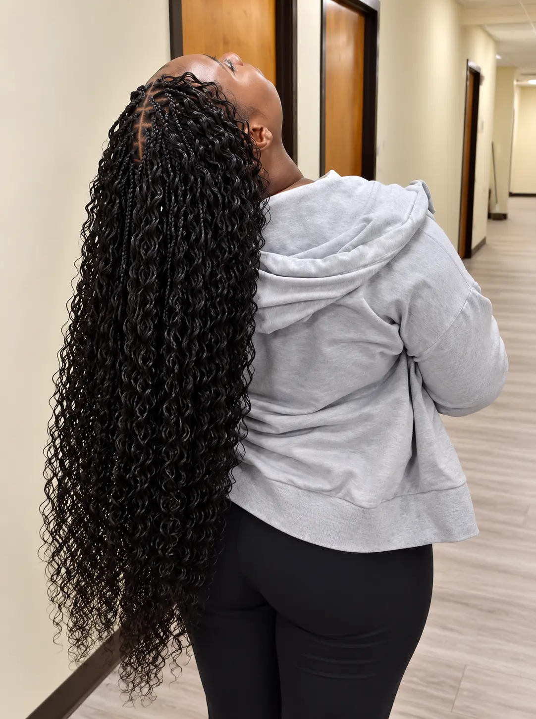 Long black boho braids with curls, head tilted back