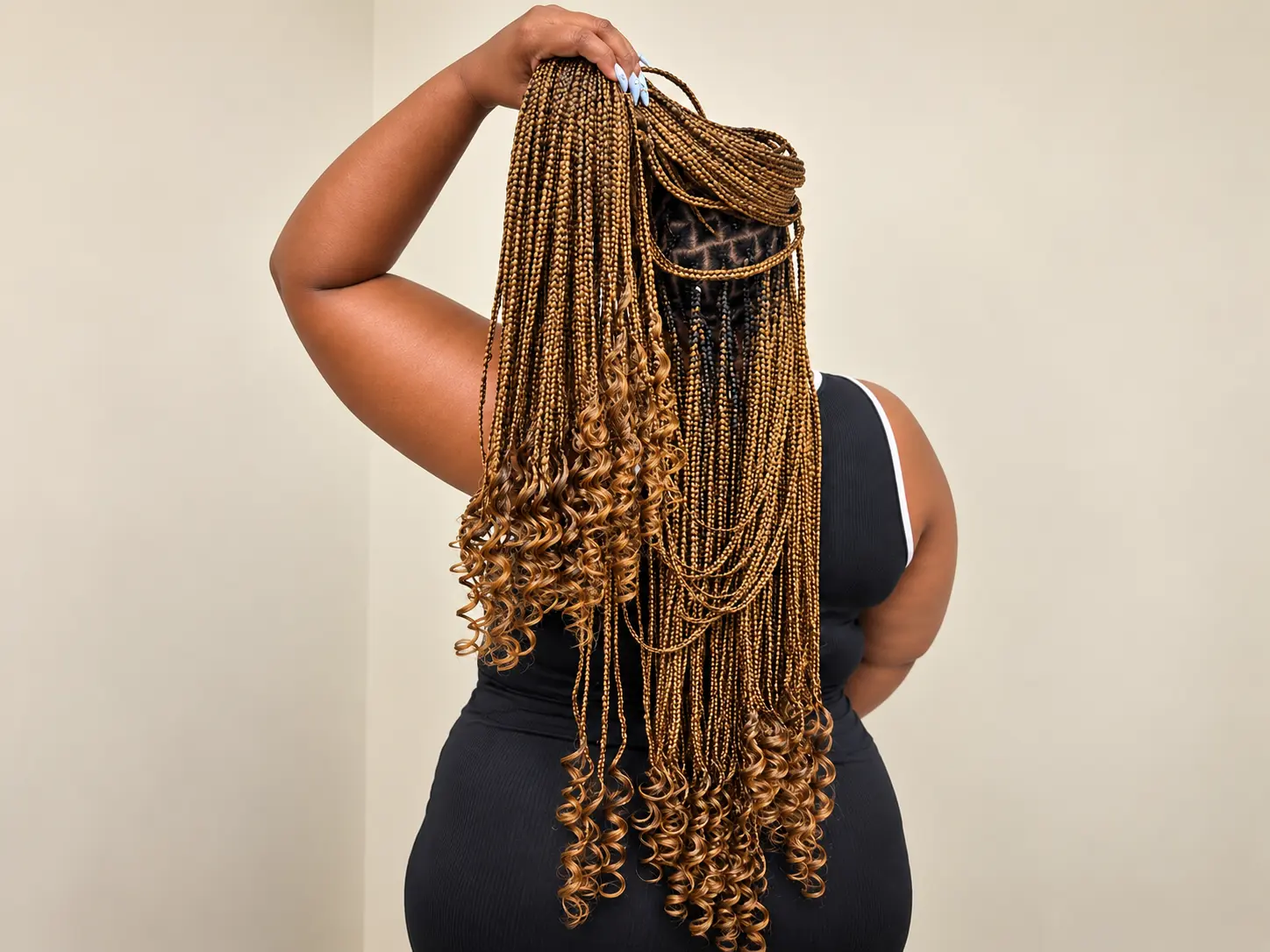 Long golden braids with cascading curls, lifted to show the length