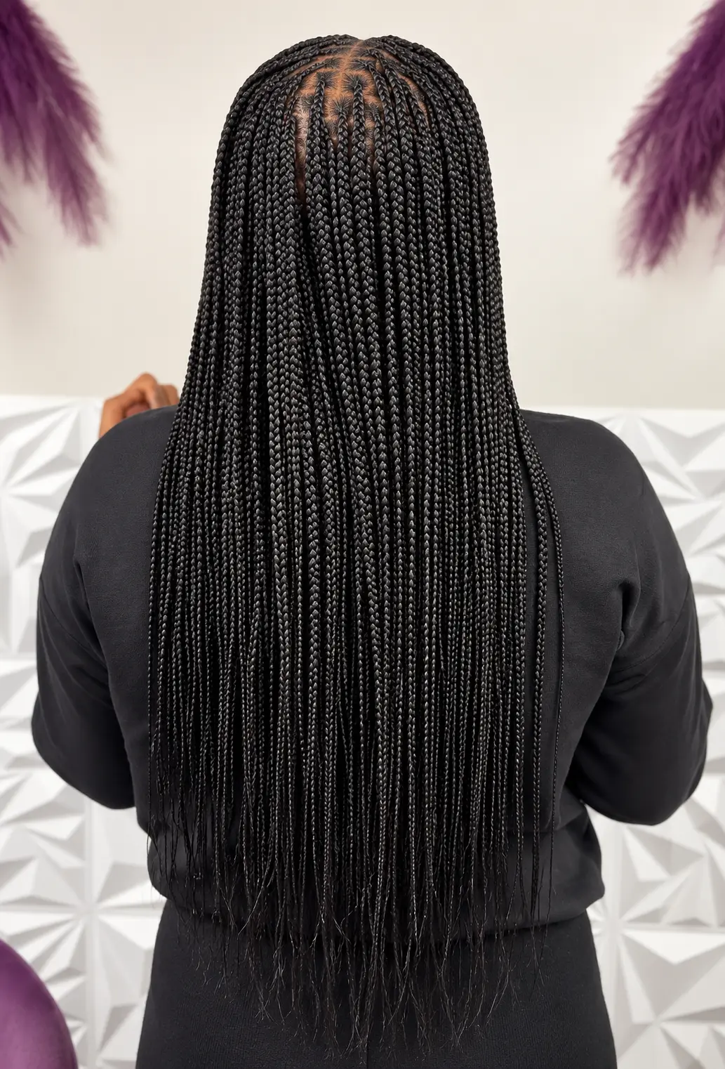 Long sleek black knotless braids, back view