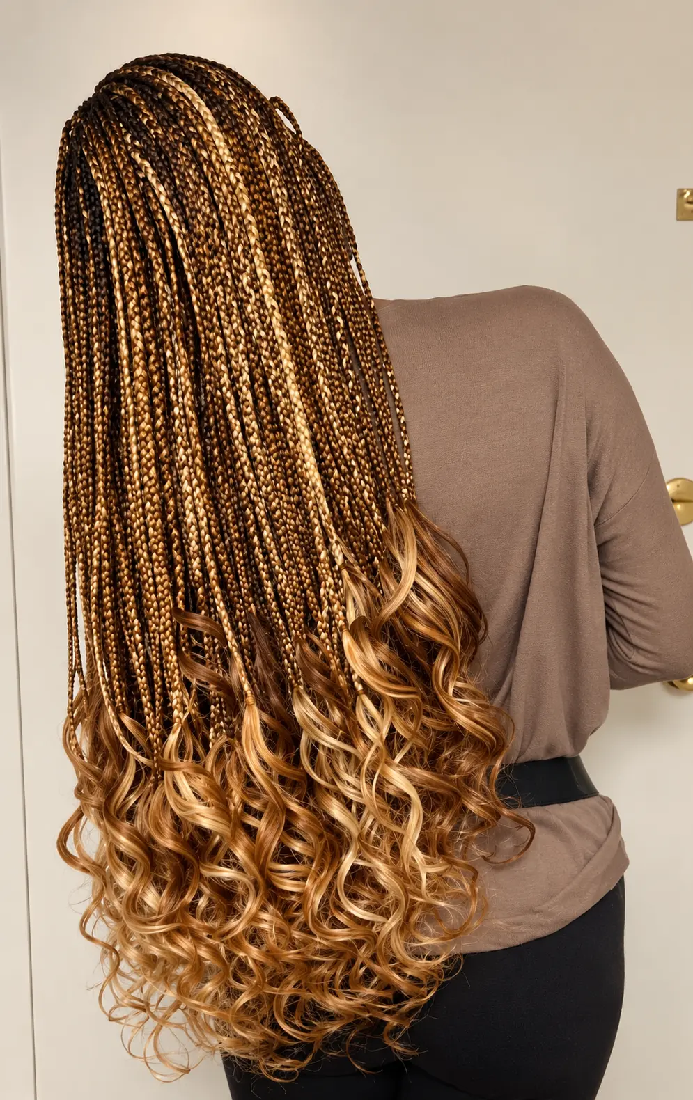 Brown and honey ombré braids with curled ends, three-quarter back view